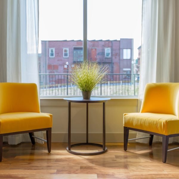Two yellow chairs by a window