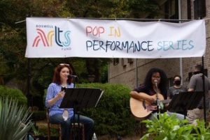 Two musicians perform outside