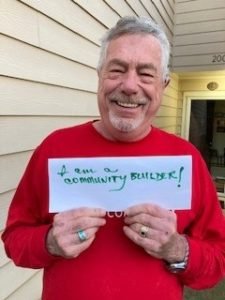 Jeff Bonnell Holding Up A Sign that Says "I Am A Community Builder!"
