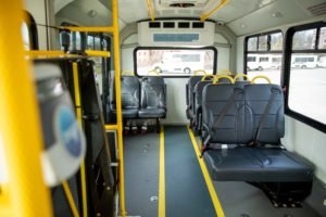 The interior of a MARTA Reach shuttle shows spacious seating and a wheel chair accessible zone. 
